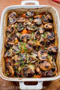 a casserole dish filled with mushrooms and carrots