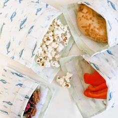 three bags filled with food sitting on top of a table