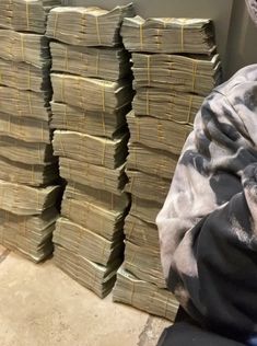 stacks of money sitting on the ground next to each other