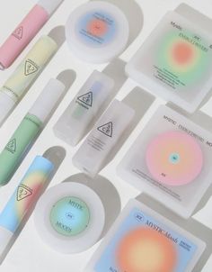 the contents of an assortment of cosmetic products displayed on a white surface with different colors and shapes