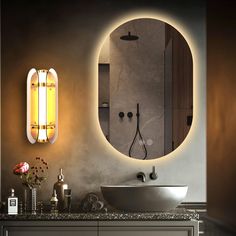 a bathroom with a sink, mirror and lights on the wall next to each other