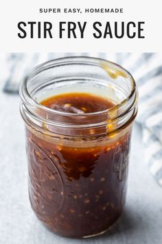 a jar filled with homemade stir fry sauce on top of a white tablecloth and text overlay reads, super easy homemade stir fry fry sauce