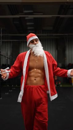 a man dressed as santa claus in a gym