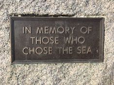 a plaque that reads in memory of those who chose the sea on a granite wall