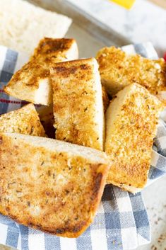 some bread sticks are on a plate with a blue and white checkered napkin