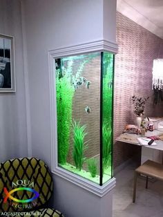 a fish tank in the corner of a room with plants and other things inside it