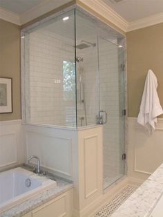 a bathroom with a walk in shower next to a bath tub