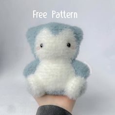 a hand holding a blue and white teddy bear with the words free pattern on it