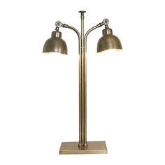 a pair of lamps sitting on top of a metal stand with two lights attached to it