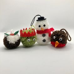 crocheted snowmen with hats and scarves are lined up on a white surface