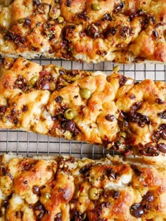 four pieces of bread with nuts and raisins on it sitting on a cooling rack