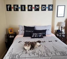 a cat laying on top of a bed in a bedroom