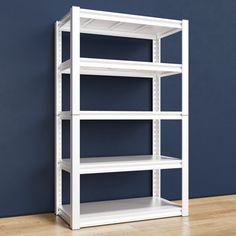 an empty white shelving unit against a blue wall in a room with hardwood floors