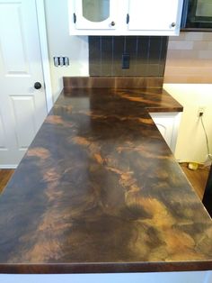 a counter top in a kitchen with white cabinets