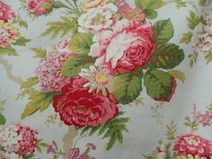 a floral print fabric with pink and red flowers on white background, close up view