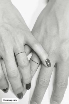 two hands holding each other with rings on their fingers