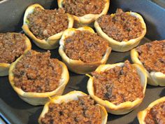 some taco cups are sitting on a baking pan and ready to be cooked in the oven