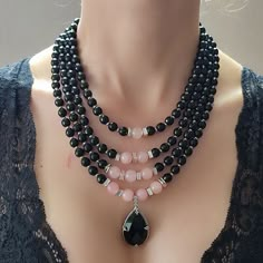 This striking Black Agate Women Pendant necklace is a true statement piece of handmade jewelry, featuring a layered design of black onyx gemstones and natural quartz beads. The pendant itself is crafted from high-quality black agate, adding a touch of elegance and sophistication to this already stunning accessory. Black agate is believed to promote inner strength and calmness, making this necklace a meaningful and thoughtful gift for a loved one. It also serves as a beautiful birthstone gift for those born in February, as onyx is the birthstone for that month. The necklace is made with a durable chain and clasp, ensuring that it can be worn and enjoyed for a long time. ⭐ Package included: One Handmade Necklace ⭐ Necklace Length: 45 - 49 - 52 - 55 cm ⭐ Material: Onyx, Quartz, Agate, Hematit Unique Statement Necklace, Natural Gemstone Necklace, Tiger Eye Jewelry, Mother Of Pearl Jewelry, Black Onyx Necklace, Onyx Necklace, Jewelry Model, Agate Jewelry, Moonstone Jewelry