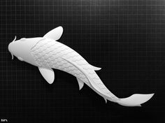 a paper cut out of a koi fish on a black background with grids