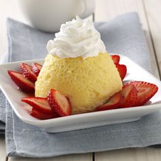 a dessert with whipped cream and strawberries on a plate