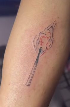 a woman's leg with a tattoo on it that has a burning match between her legs