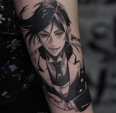 a woman's arm with an anime character tattoo on it