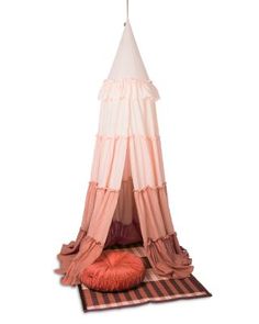 a pink and white tent sitting on top of a rug