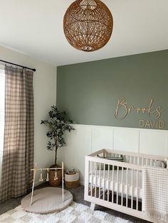 a baby's room with a white crib and green walls