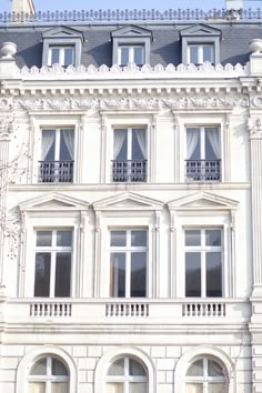 a large white building with many windows and balconies