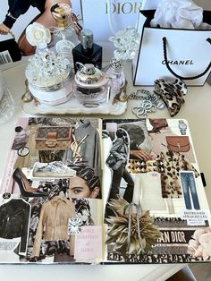 an assortment of women's perfumes and accessories on a table