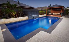 an empty swimming pool in the middle of a backyard