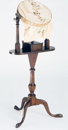 an old fashioned wooden table with a hat on it