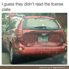 a red car parked on the side of a road next to a stop sign that reads, i guess they didn't read the license plate