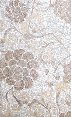 a close up view of a tile floor with flowers and swirls on the side