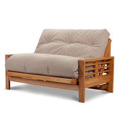 a wooden futon with beige cushions on it's back and armrests