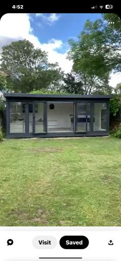 an image of a house in the middle of a yard with grass and trees around it