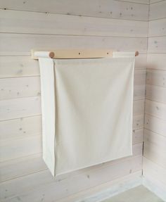 a white towel hanging on a wooden wall