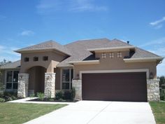 a large house with two garages in front of it