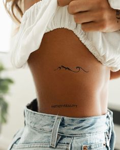 a woman with a tattoo on her stomach