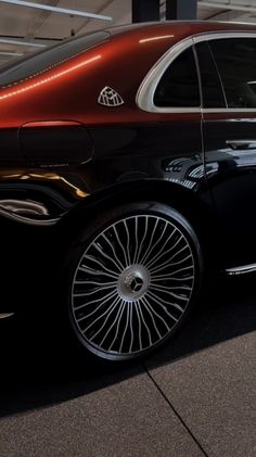 a black car with chrome rims parked in a garage