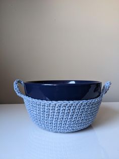 a blue bowl sitting on top of a white table