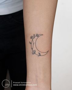 a woman's arm with a small tattoo on it