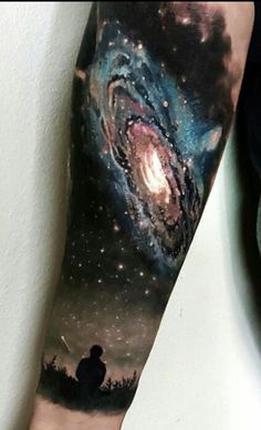 a man's arm with an image of the milky sky and stars on it