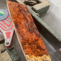 a large piece of wood sitting on top of a table next to a pair of scissors