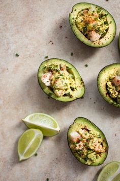 four avocados with limes and seasoning on the side