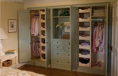 an open closet with clothes and other items in it