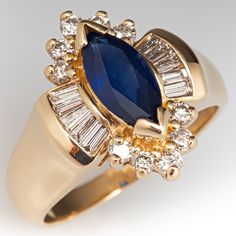 This beautiful sapphire ring is centered with a marquise mixed cut sapphire, weighing 1.40 carats, in a chevron setting. The top is accented with ten (10) prong set round brilliant cut diamonds and ten (10) channel set, baguette cut diamonds. The ring measures 17.7mm at the top, rises 7.5mm above the finger, tapering to 2.5mm wide and 0.8mm thick at the base of the shank. It is currently a size 7.75. Luxury Marquise Sapphire Ring In Yellow Gold, Marquise Sapphire Ring With Brilliant Cut, Marquise Cut Sapphire Ring For Anniversary, Marquise Sapphire Ring For Formal Occasions, Marquise Sapphire, Ring Jewellery Design, Baguette Cut Diamond, Pretty Rings, Channel Set