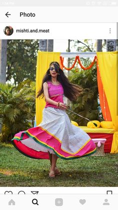 a woman in a colorful dress is dancing