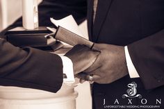 two men in suits shaking hands over papers