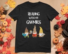 reading with my gnomes t - shirt on top of autumn leaves and pumpkins